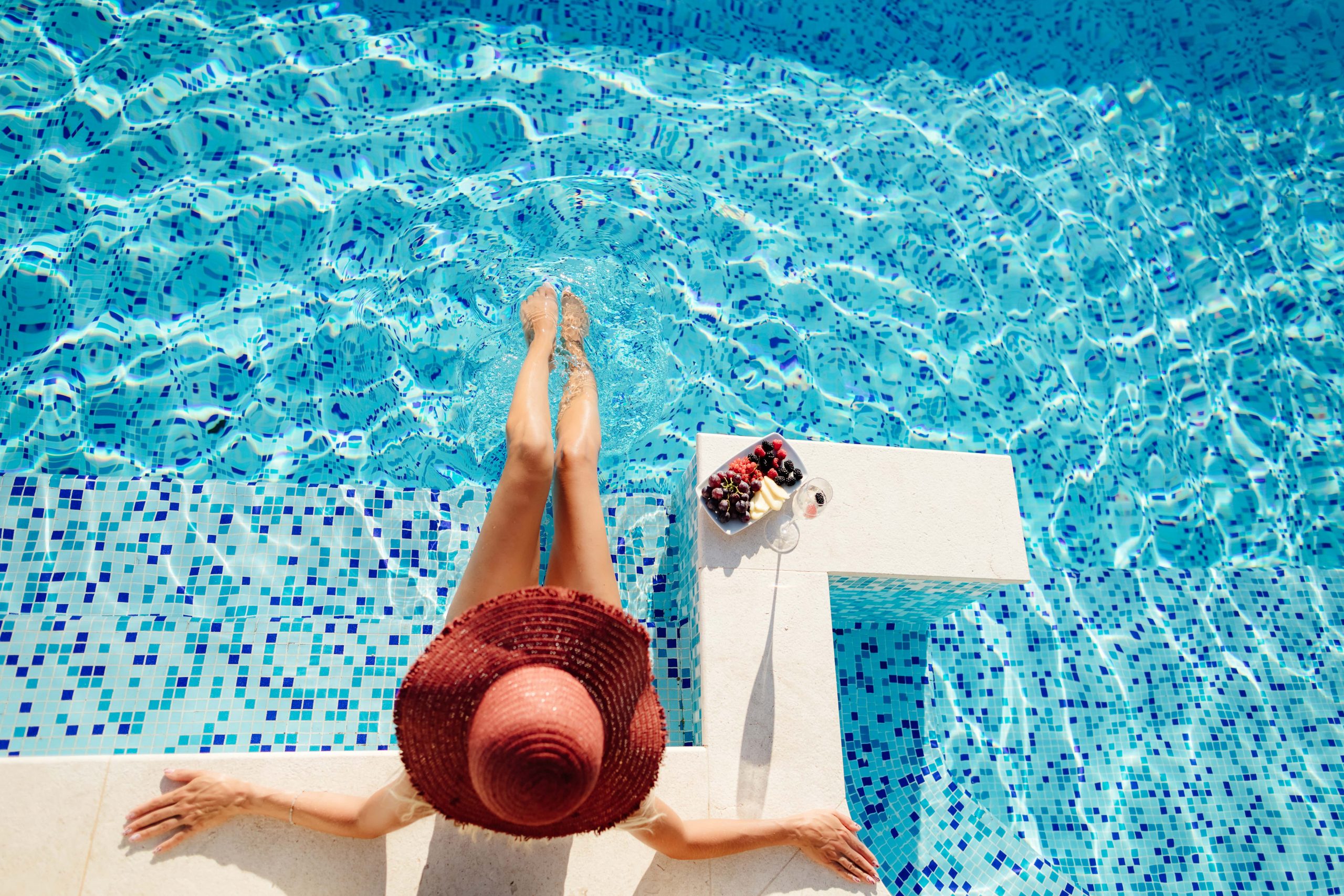 woman-relax-in-swimming-pool-outdoors-HLRMHJM-min